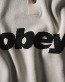 Obey Sport Polo Sweater Unbleached Multi, polosweater van 100% viscose met gestreepte rib polokraag, contrastpanelen en relaxed fit, maten S-XXL, verkrijgbaar bij Revert 95 Haarlem