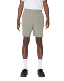 Obey Travel Short in Vetiver, 92% polyester 8% spandex 3.5 oz lichtgewicht short met elastic waistband rounded drawcord faux fly front slash pockets zipper closure back welt pocket reflective Obey logo op been relaxed fit 7 inch inseam in gedempte olijfgroene Vetiver colorway, verkrijgbaar bij Revert 95 Haarlem