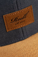 Reell Suede Cap, 80% cotton 20% suede 6-panel ball cap geïnspireerd op jaren 50 stijlen met flat suede rand aan klep kleur-geblokeerd design embossed Reell Script Logo Patch op voorkant en script logo flag snapback closure one size fits most, verkrijgbaar bij Revert 95 Haarlem