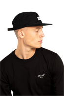 Reell 5-Panel Cap Cord, 100% cotton corduroy relaxed 5-panel snapback met structural brim stitching Reell woven logo patch op voorkant adjustable snapback closure met logo flag en woven brand label verkrijgbaar in Copper Brown Cord Hedge Cord en Black, verkrijgbaar bij Revert 95 Haarlem