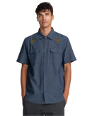 RVCA Rosa Chambray Shirt in Indigo, lichtgewicht 100% katoenen chambray overhemdje met Rosa botanische print regular fit en kort mouw button-up sluiting, verkrijgbaar bij Revert 95 Haarlem