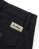Butter Goods Pleated Trousers in Washed Black, 100% cotton herringbone twill baggy fit broek met dubbele plooien op de voorkant welt pockets met flap en button closure en belt loops met internal drawcord, verkrijgbaar bij Revert 95 Haarlem
