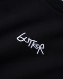 Butter Goods Tread Crewneck Sweater in Black Charcoal, 100% katoen crewneck sweater met direct geborduurd Tread logo op de voorkant en contrast stitching in zwart en houtskoolgrijs, verkrijgbaar bij Revert 95 Haarlem